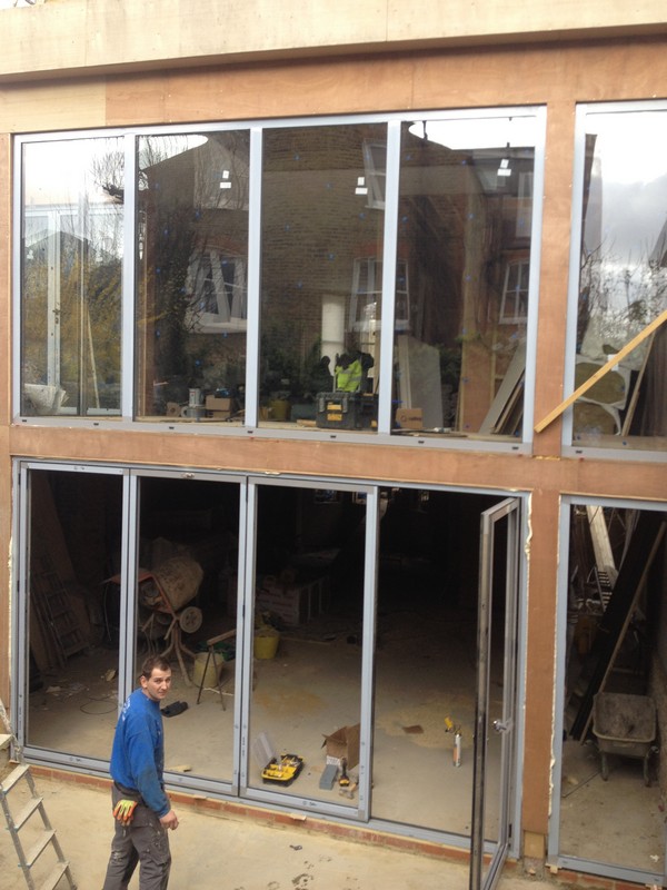 Aluminium bi-fold doors with two-storey glazing in Ladbroke Grove