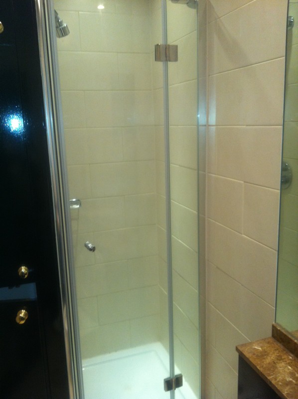 Frameless glass shower enclosure with chrome fittings in Ladbroke Grove