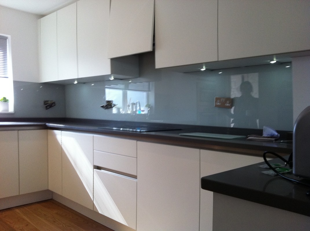 Grey glass kitchen splashback with LED lighting in Ladbroke Grove