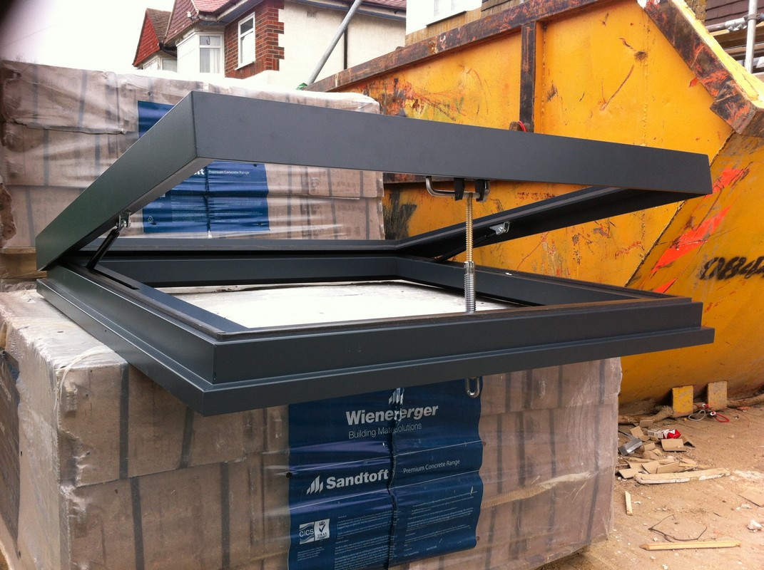 Opening flat roof skylight in anthracite grey installed in Ladbroke Grove