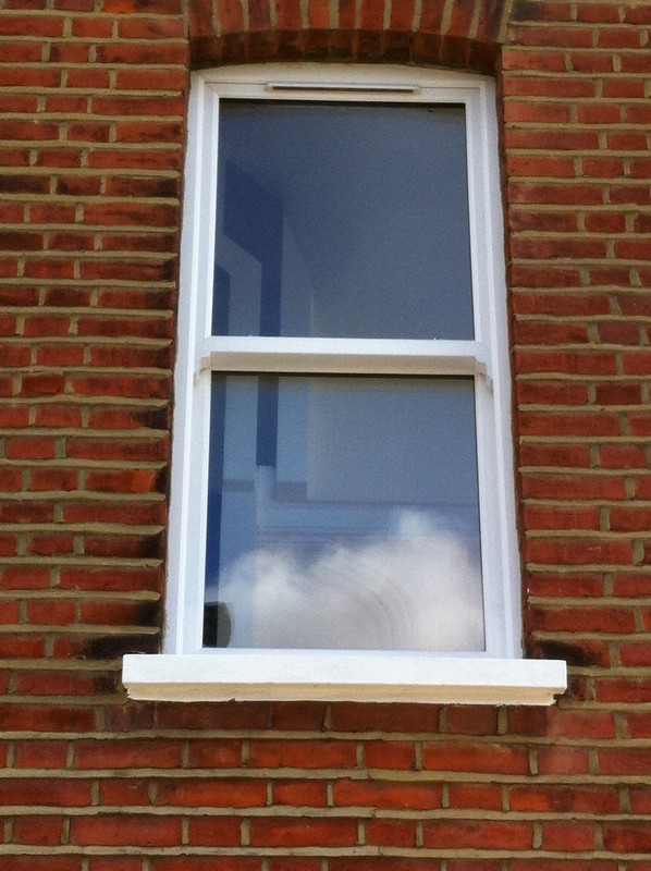 uPVC sash window on Victorian red brick house in Ladbroke Grove